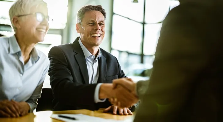 A couple meeting with a financial advisor to review their portfolio.
