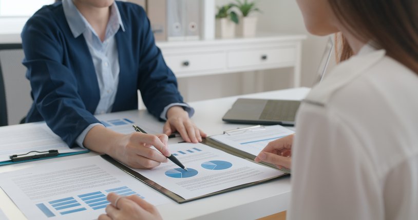 A woman discussing ETFs with her advisor.