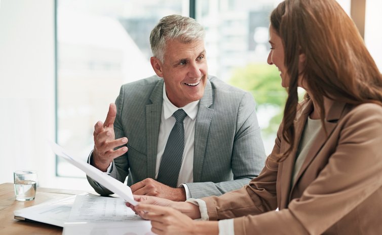 A client reviews her cross-border portfolio with a financial advisor.